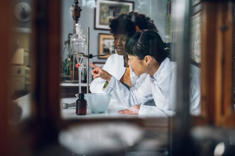 Interracial pharmacists are standing in a vintage pharmacy